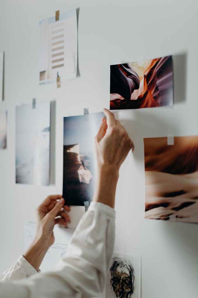 photo of person putting photo on wall